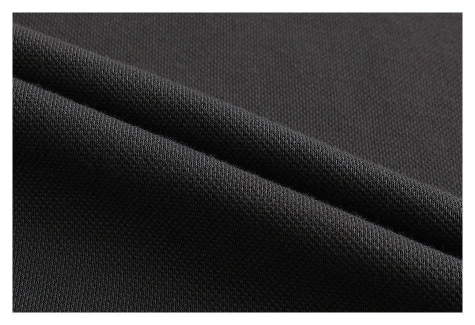 Close-up of dark charcoal fabric texture with a diagonal fold.
