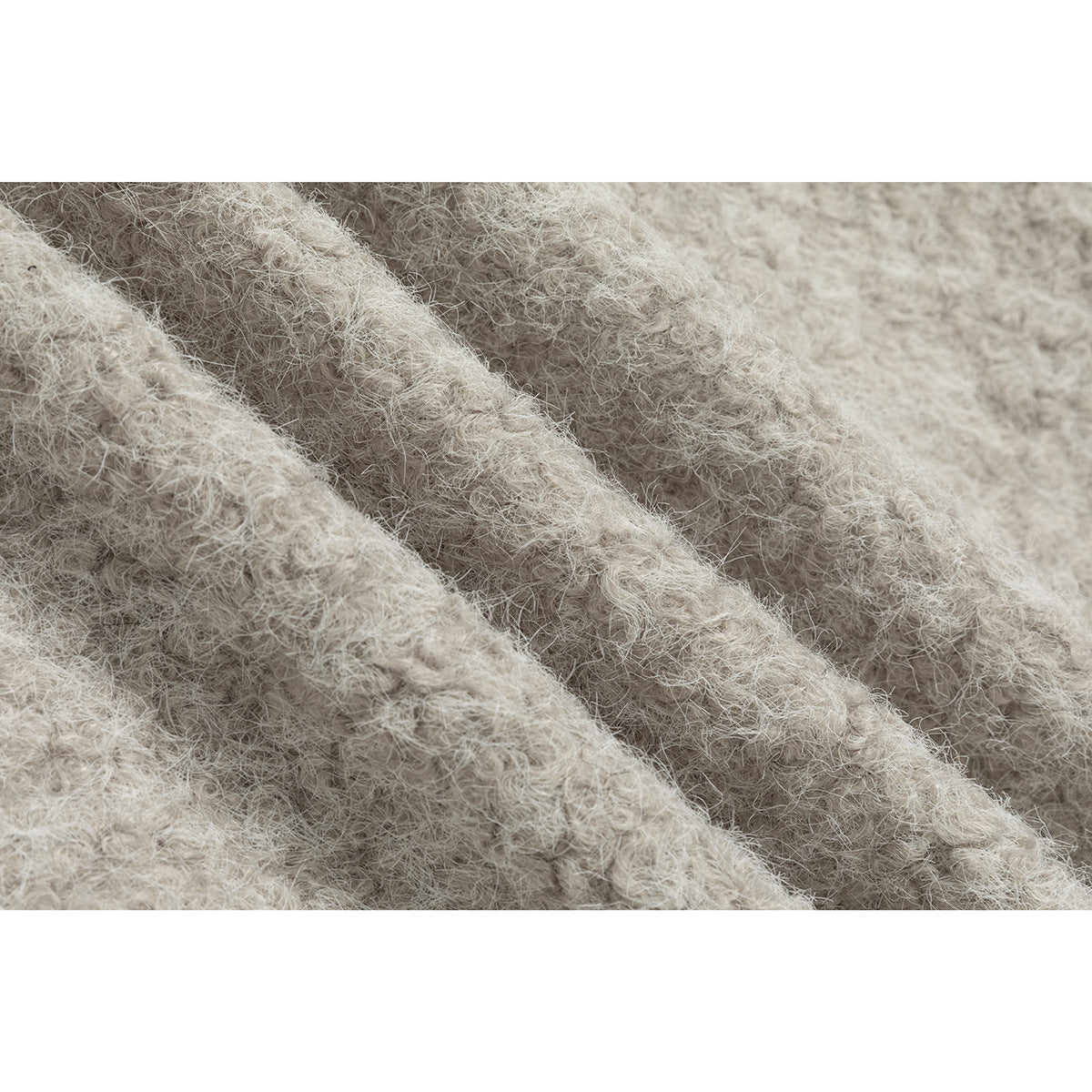 Extreme close-up of the jacket's pale beige, fuzzy textured fabric.