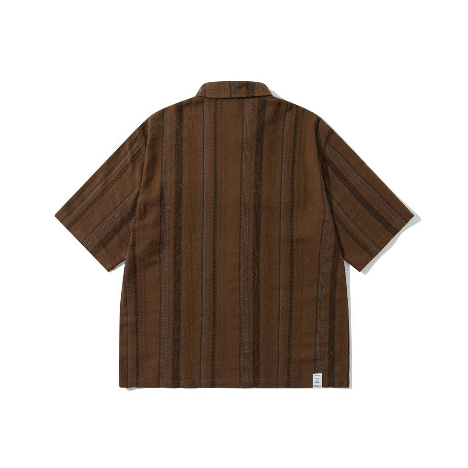 Back view of brown short-sleeve shirt with vertical textured stripes and a small label at the lower hem