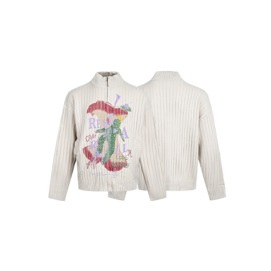 Ivory ribbed sweater shown from front and back, with a short zipper, tall collar, and colorful front graphic.