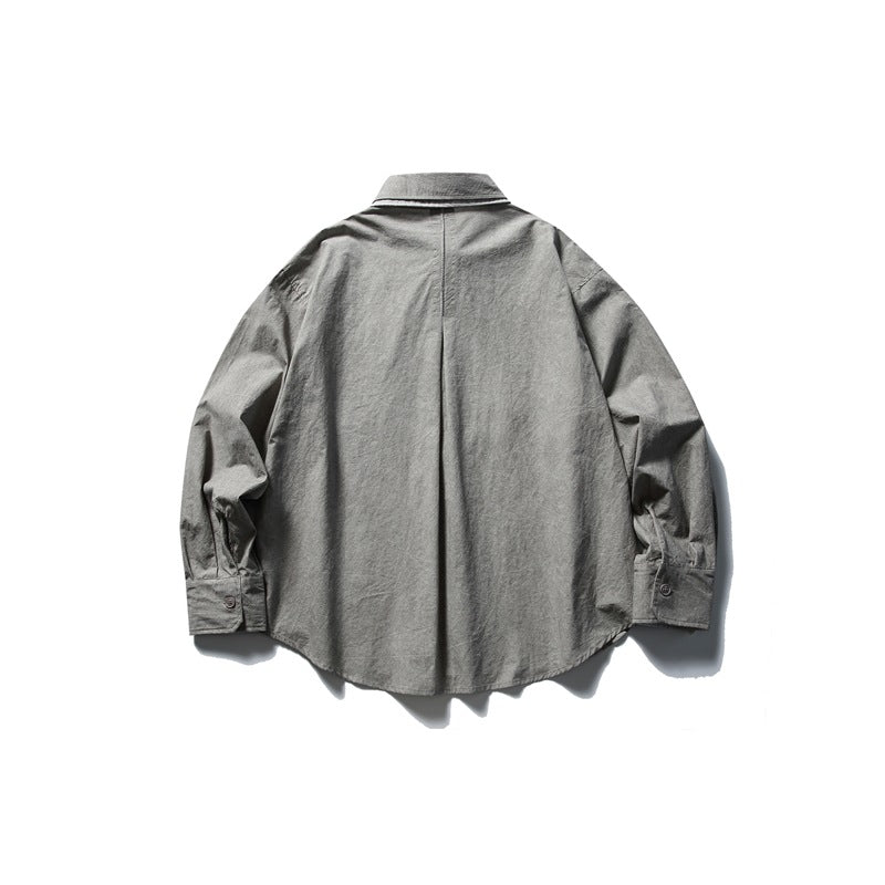 Back view of a gray long-sleeve button-up shirt with a center pleat and button cuffs.