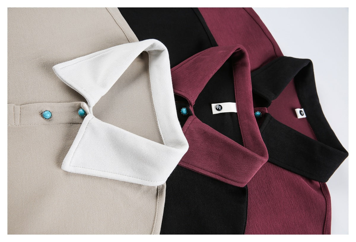 Close-up of beige, black, and burgundy collared garments with white contrast collars and turquoise buttons.