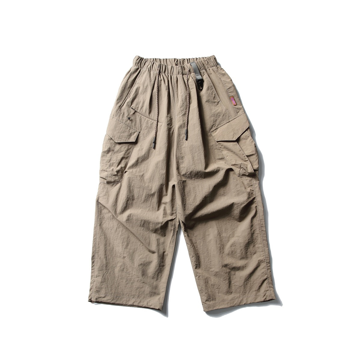 Front view of taupe wide-leg cargo pants with an elastic drawstring waist and large flap pockets.