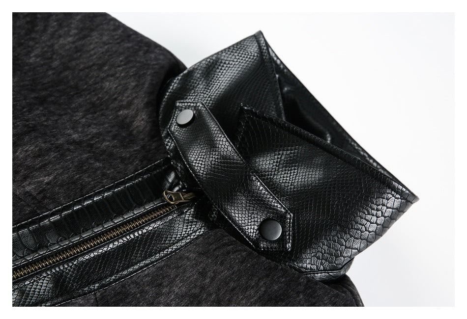 Close-up of a black reptile-embossed snap tab and zipper beside dark gray lining.