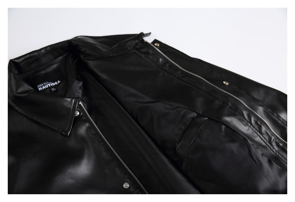 Black jacket laid open to show its front zipper, snap fasteners, collar, and interior lining.