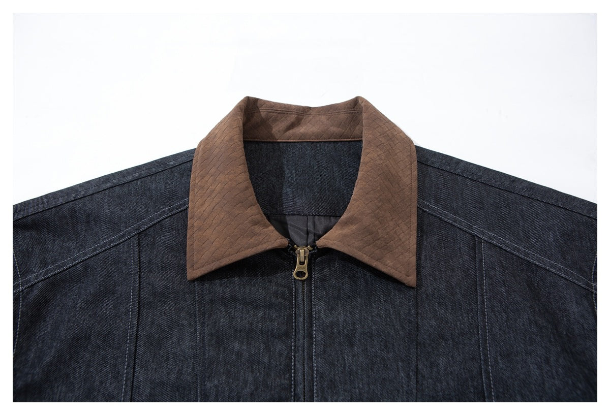 Close-up of the dark indigo jacket's front, featuring a brown quilted collar and centered zipper.