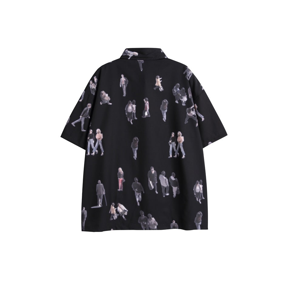Back view of a black short-sleeve collared shirt covered in a scattered print of small people.