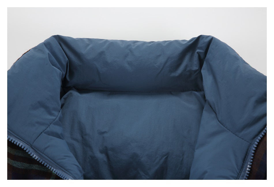 Open jacket interior showing dark blue lining, padded collar, and plaid outer fabric at the edges.
