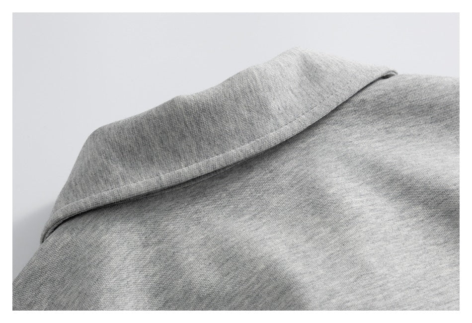 Close-up of a gray garment collar and its stitched edge.