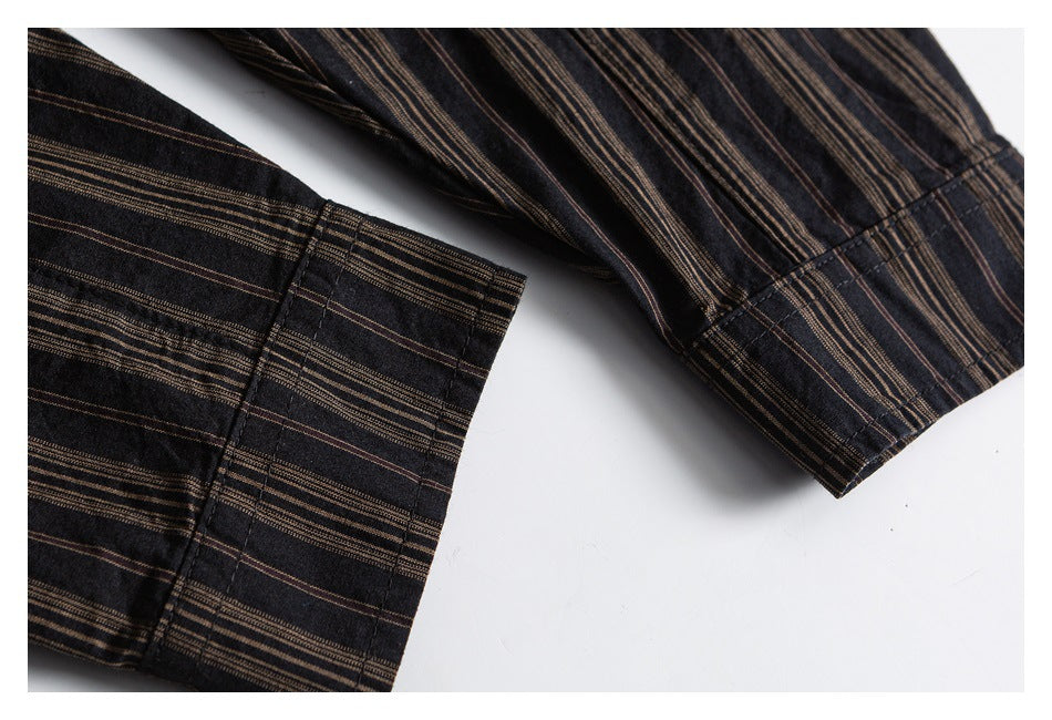 Close-up of two cuffs showing the dark shirt's narrow brown stripe pattern and stitching.