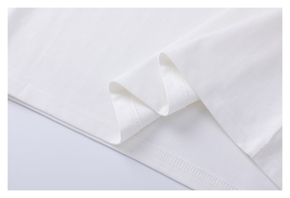 Close-up of the white T-shirt's folded lower hem and visible overlock stitching.