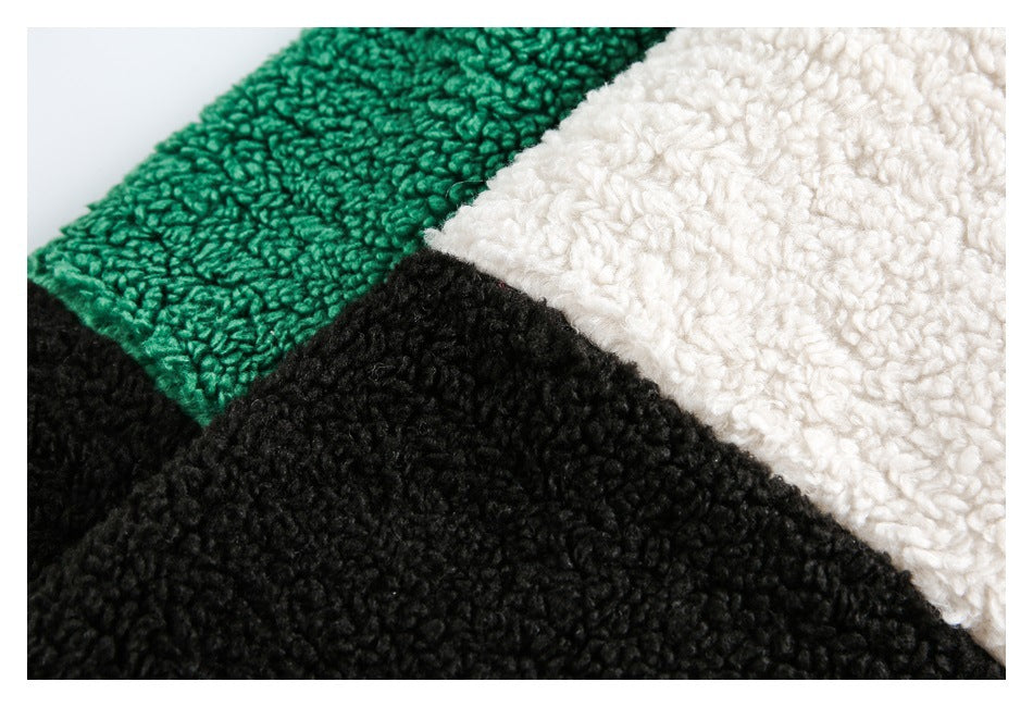 Close-up of green, cream, and black textured color-block fabric.
