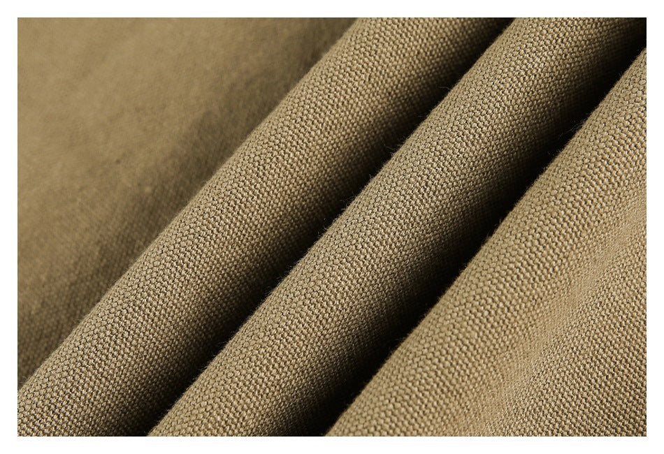 Close-up of tan-brown fabric with a visible woven texture and soft folds.