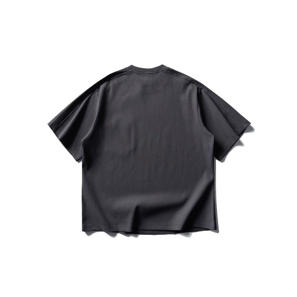 Back view of a dark gray waffle-knit short-sleeve crew neck T-shirt with a relaxed boxy shape