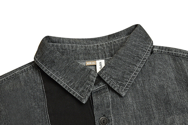 Close-up of a charcoal gray shirt collar and black button placket with contrasting white stitching.