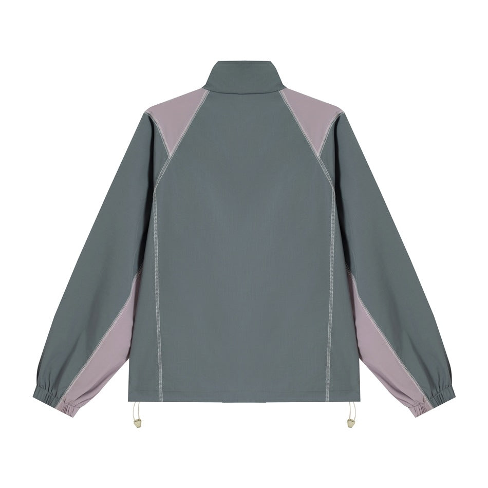 Back view of a slate gray jacket with lilac shoulder and sleeve panels, contrast stitching and an adjustable hem.