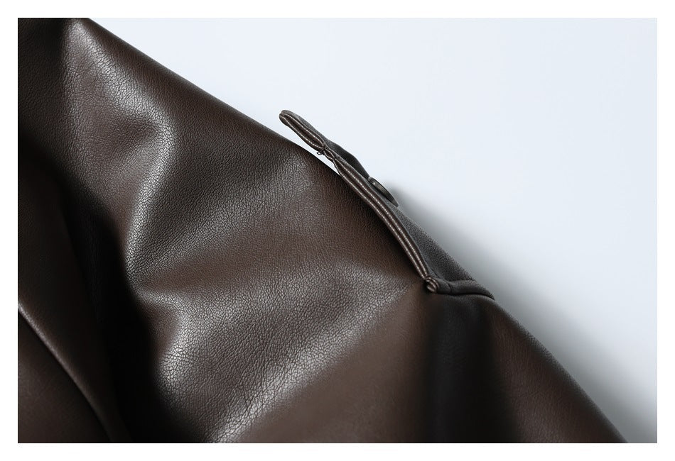 Close-up of a dark brown jacket sleeve with a narrow zippered detail.