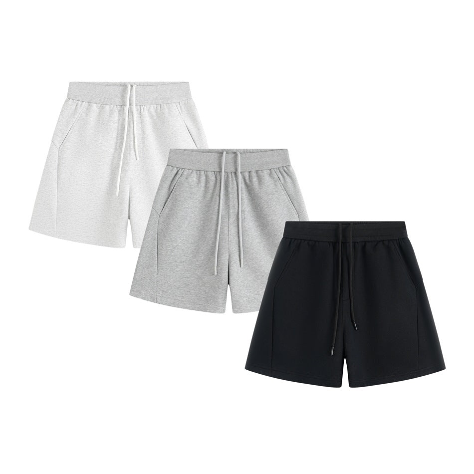 Three pairs of casual shorts with elastic waistbands and drawstrings in light gray, gray, and black.