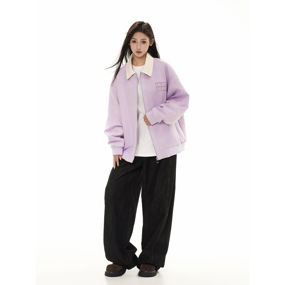 Front view of a model wearing a lilac jacket with a cream collar, white shirt, and loose black trousers.