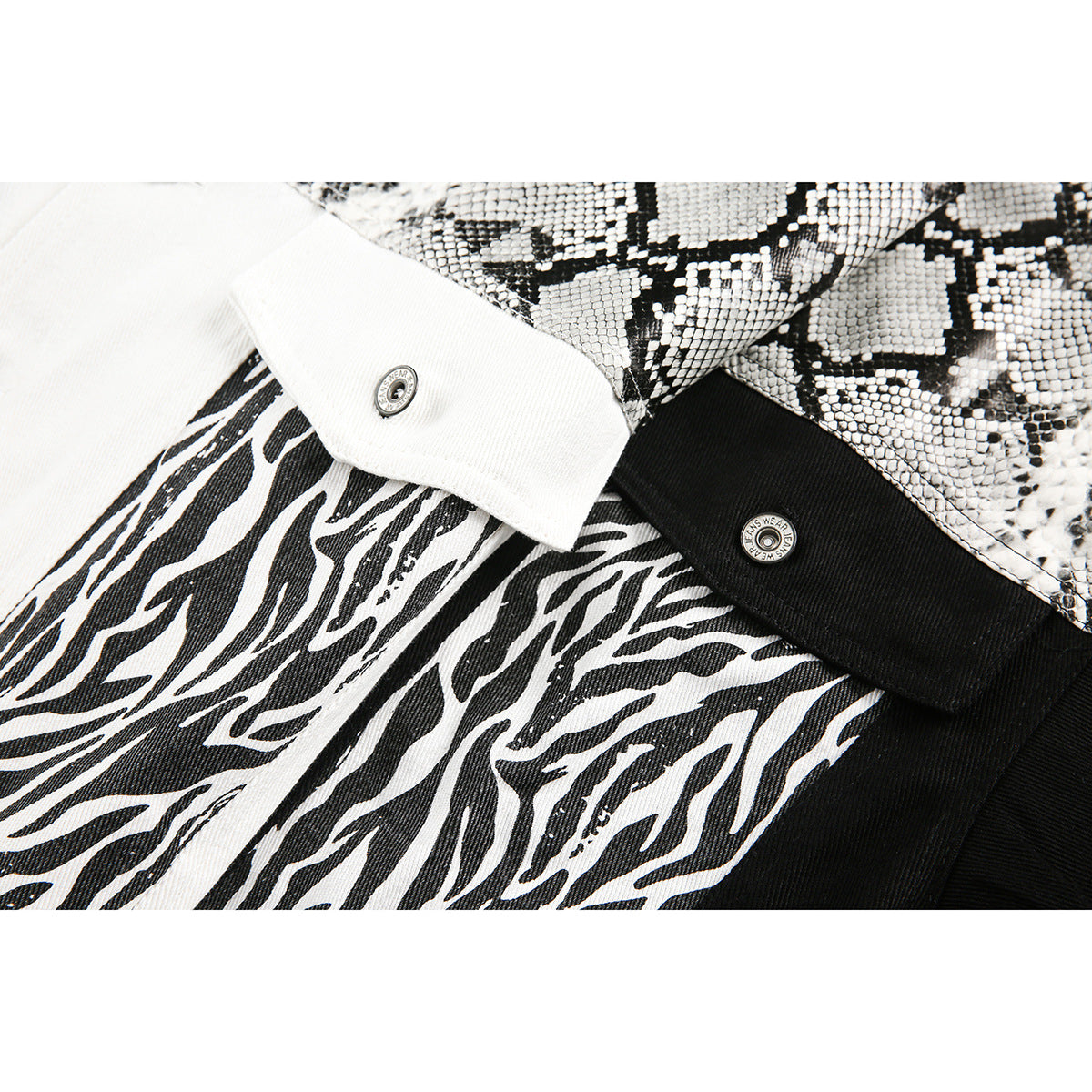 Close-up of black-and-white patterned jacket panels, contrasting collars, and metal snap buttons.