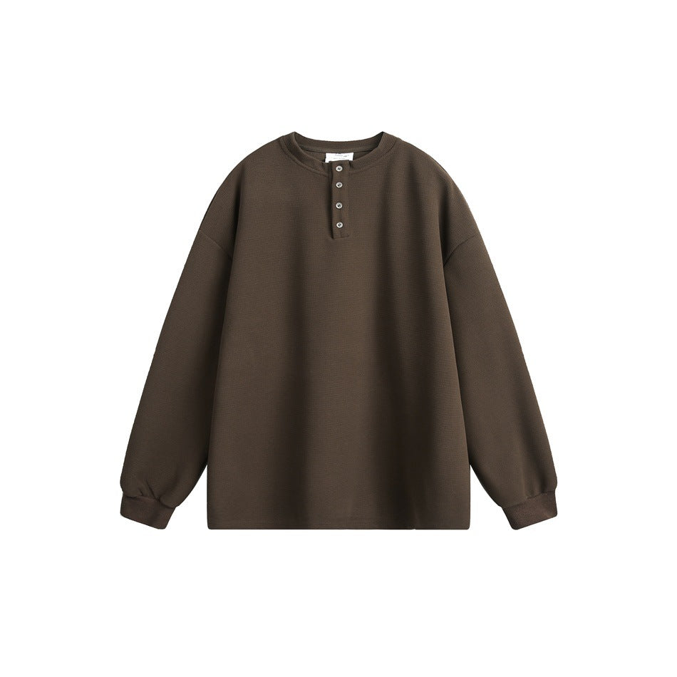 Brown waffle-textured long-sleeve Henley top with four buttons and ribbed cuffs, flat lay on white