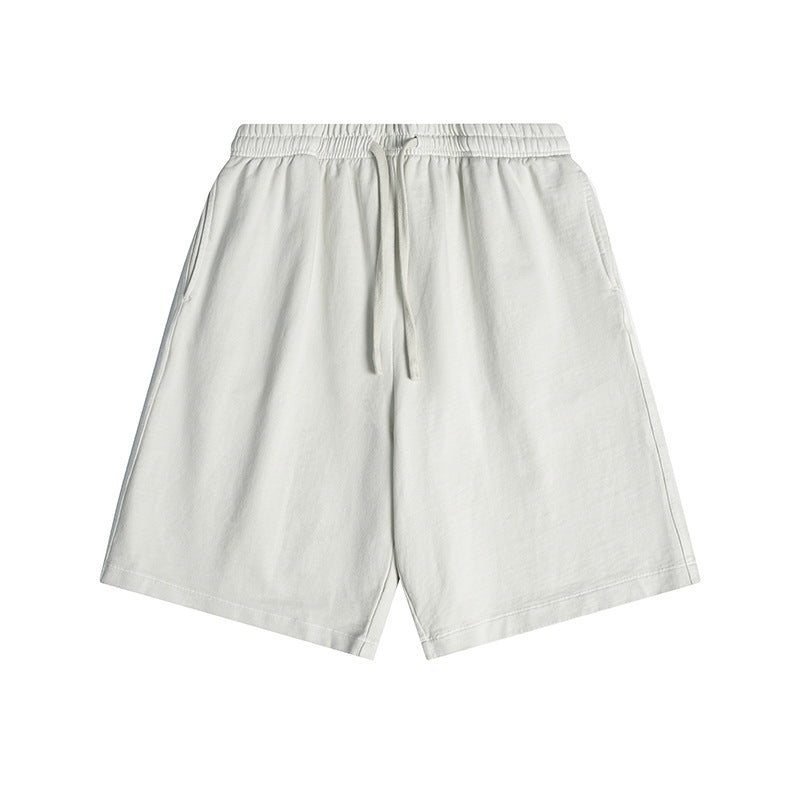 Off-white knee-length drawstring shorts with elastic waistband and side pockets, flat lay front view