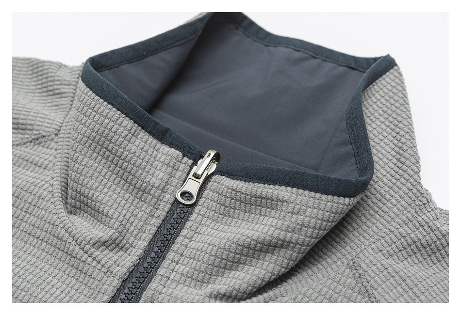 Close-up of a gray textured jacket collar, dark lining and front zipper.
