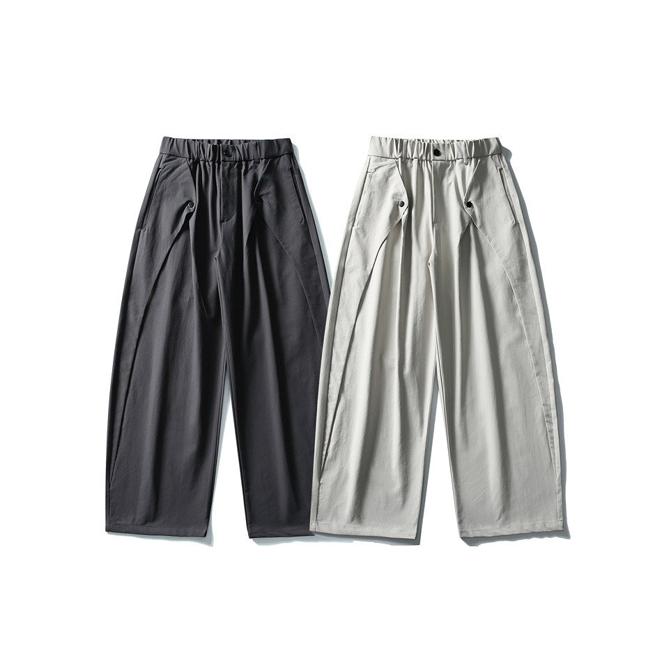 Front view of wide-leg trousers in charcoal and light gray, with gathered waistbands and angled front pockets.