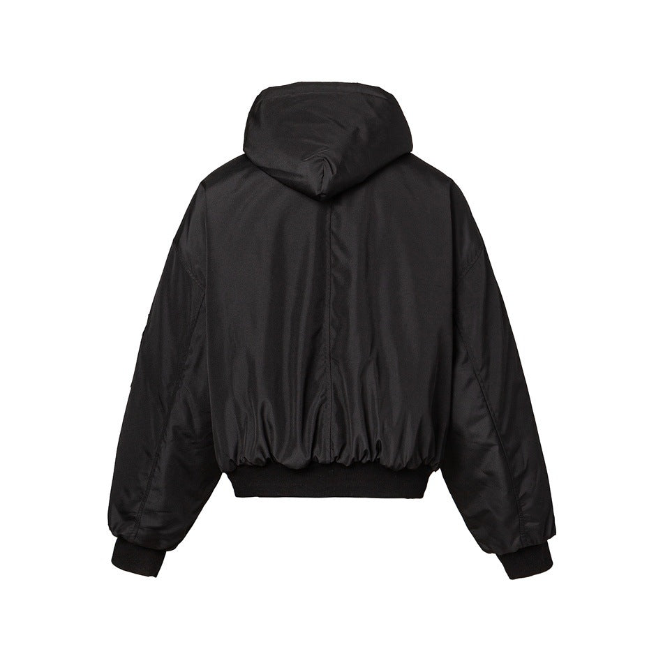 Back view of a black hooded jacket with long sleeves, a gathered hem, and ribbed cuffs.
