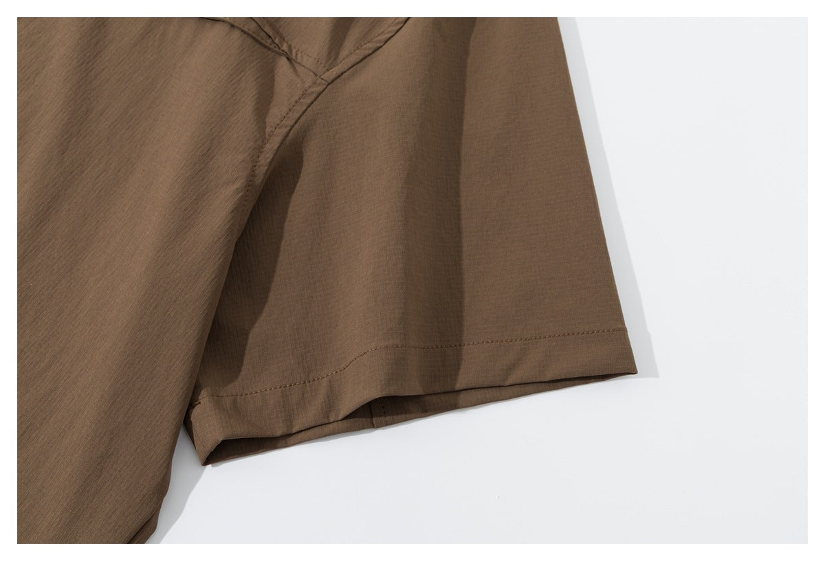 Close-up of the brown shirt's short sleeve, showing its stitched cuff and seam.
