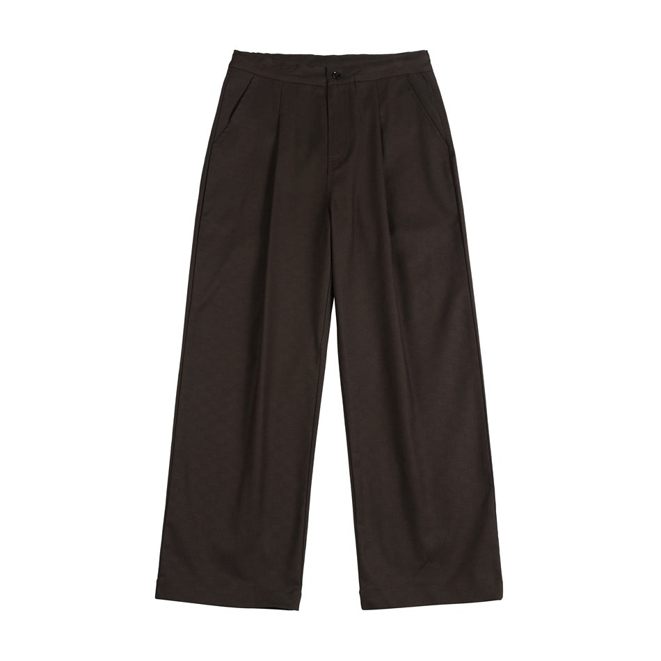 Dark brown wide-leg pleated trousers with front button closure and side pockets, flat lay on white