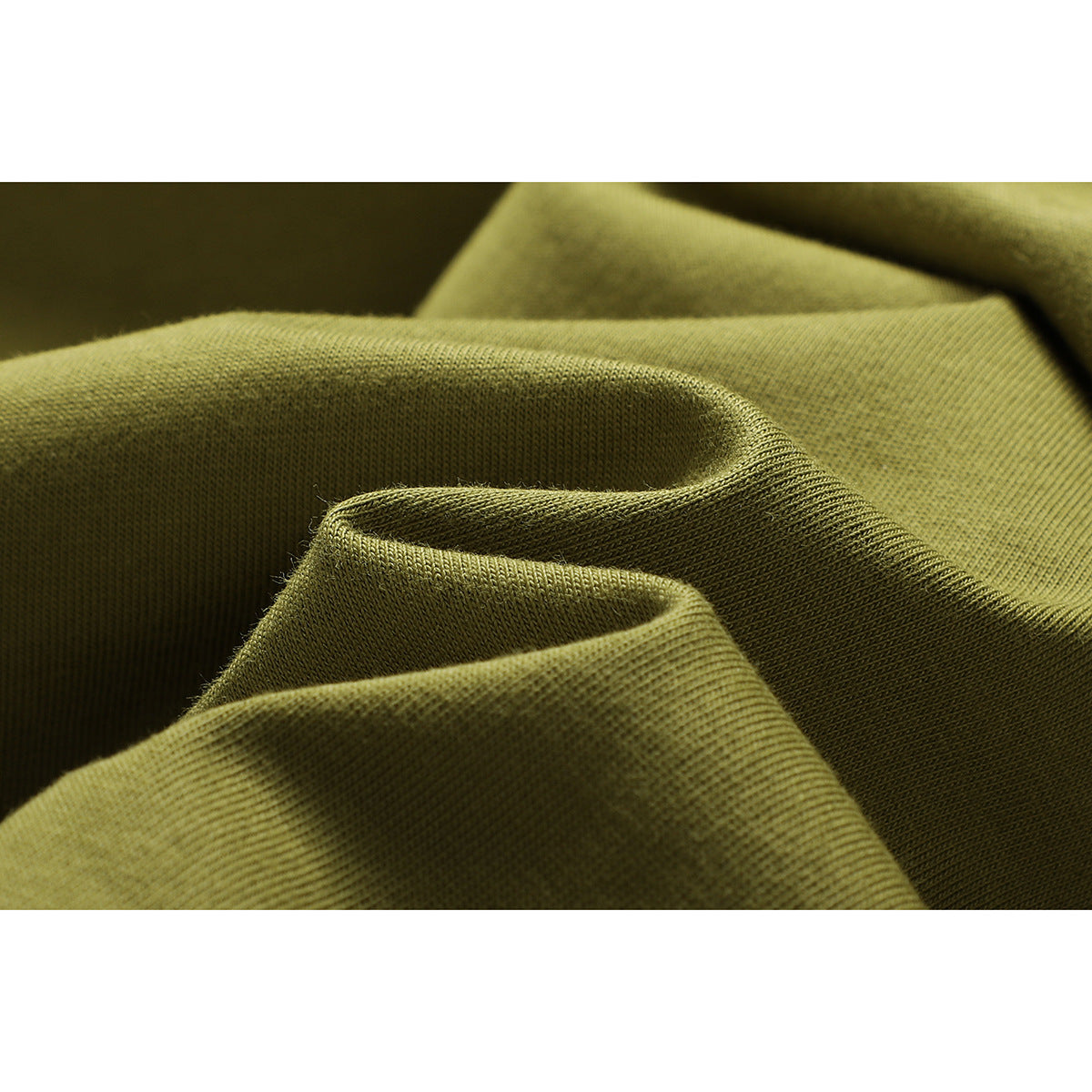Macro view of olive-green fabric folded to show its surface texture.