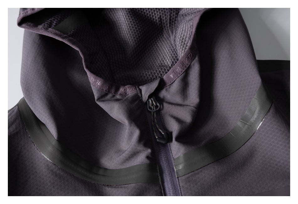 Close-up of the jacket's mesh-lined hood opening, front zipper, and dark seam-tape accents.
