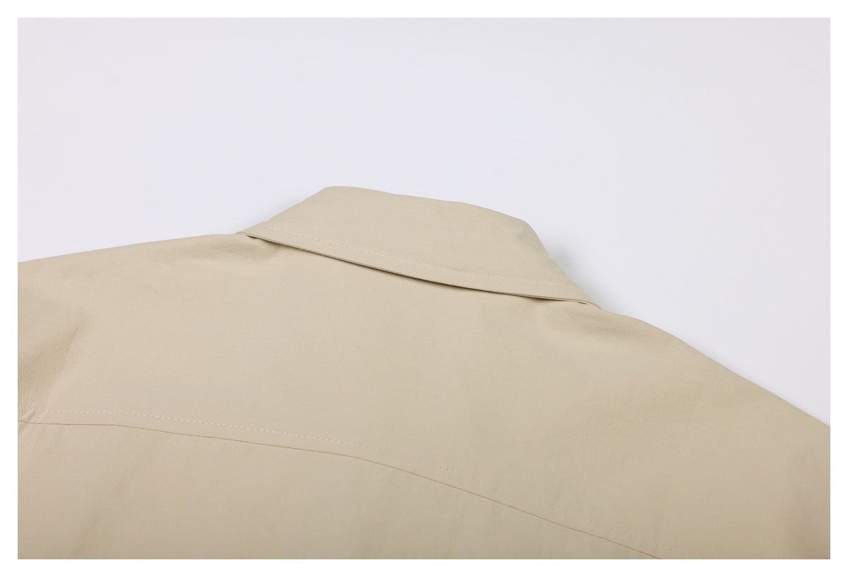 Close-up of the beige shirt's back shoulder seam and collar.