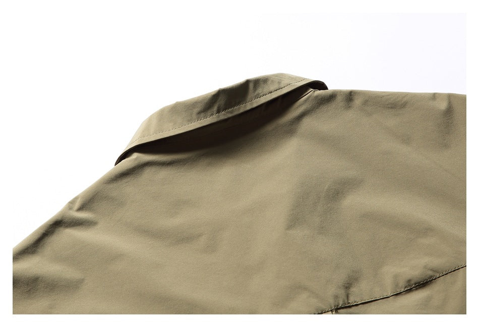 Cropped view of the olive-khaki shirt's back shoulder and collar with visible stitching.