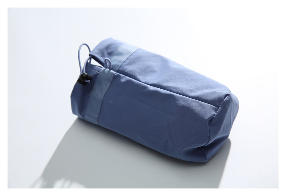 Close-up of the plain blue trouser panel with an elastic edge, drawcord, and cord lock.