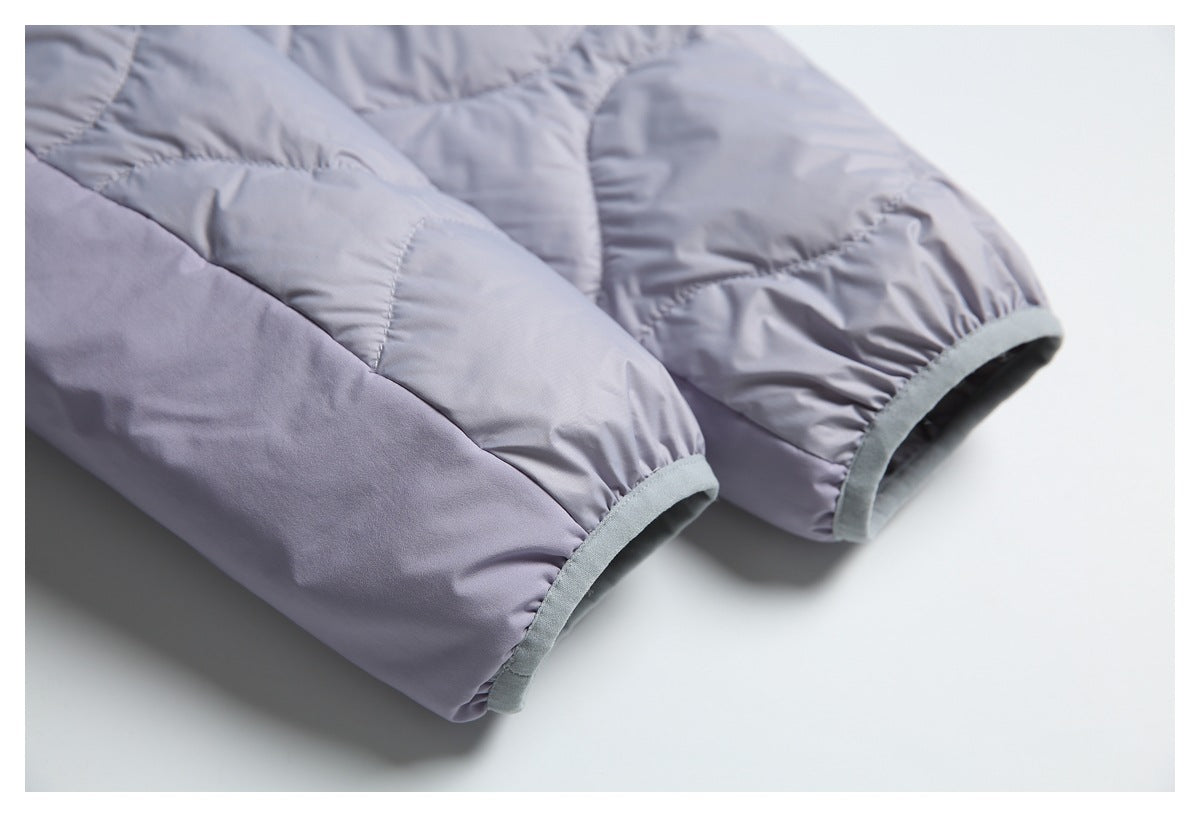 Close-up of two pale lavender-gray jacket sleeves with gray-bound cuffs and quilted stitching.