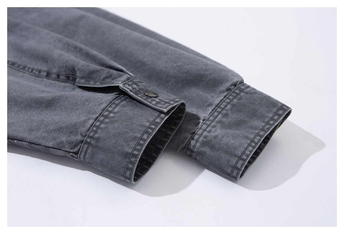 Close-up of the charcoal-gray jacket sleeve cuff with a snap-tab closure.