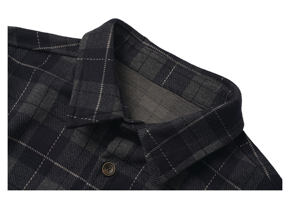 Close-up of the charcoal plaid shirt's pointed collar, inner neckline, and a dark button.