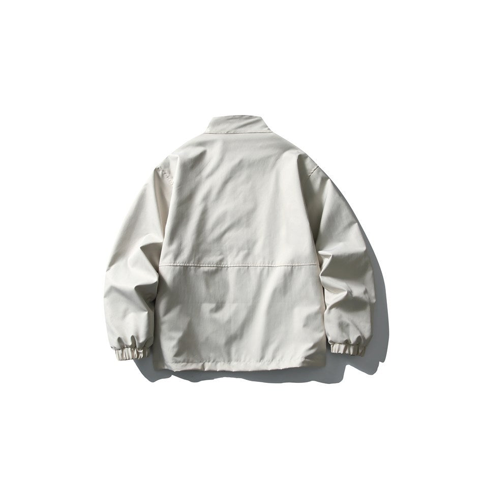 Back view of a light ivory jacket with a stand collar, gathered elastic cuffs, and a straight hem.