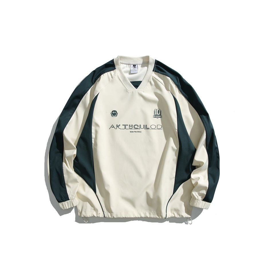 Cream V-neck raglan pullover with dark green side and sleeve panels, chest print and drawcord hem, flat lay