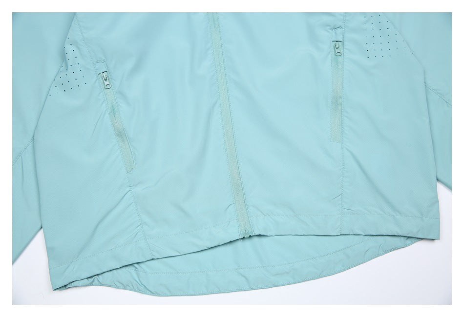 Cropped flat lay of a light aqua jacket front with a central zipper and two zip pockets.