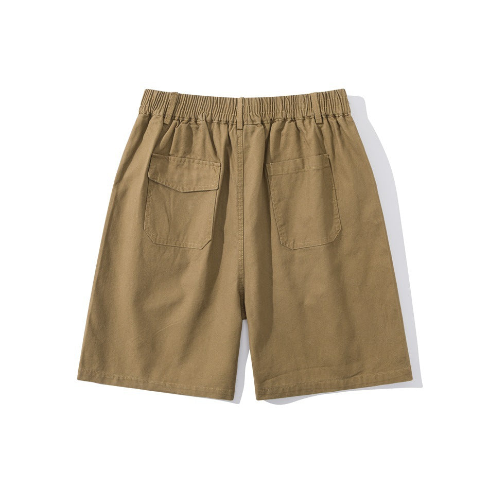 Khaki shorts flat lay, back view with elastic waistband, one flap back pocket and one open patch back pocket