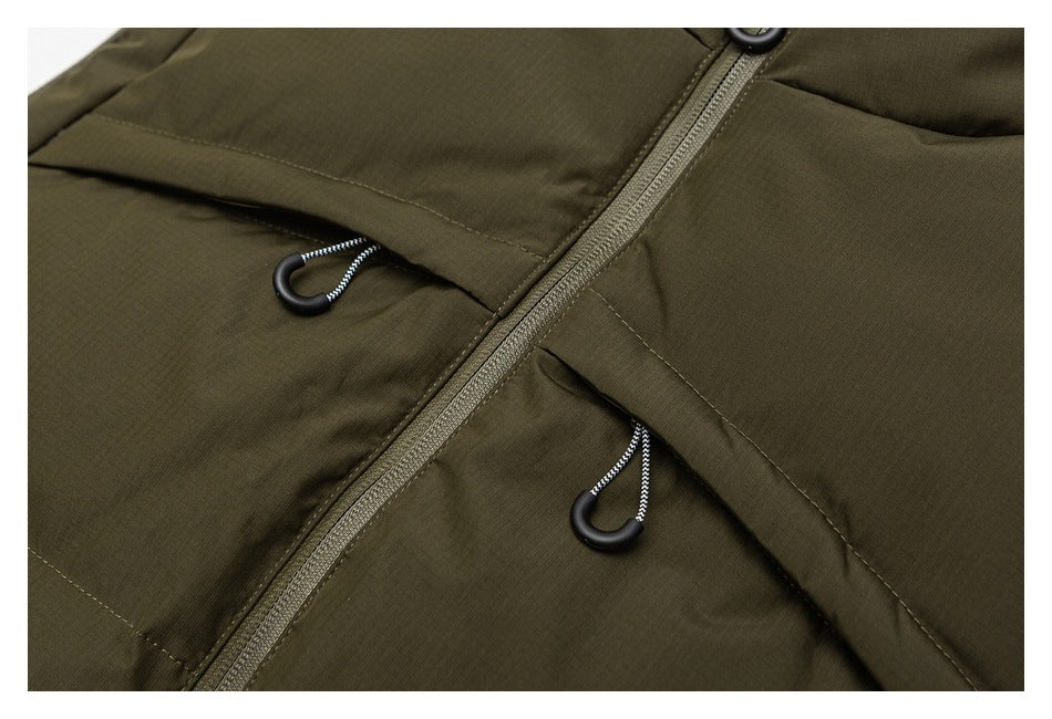 Close-up of an olive jacket's front zipper and two flap pockets with cord pulls.