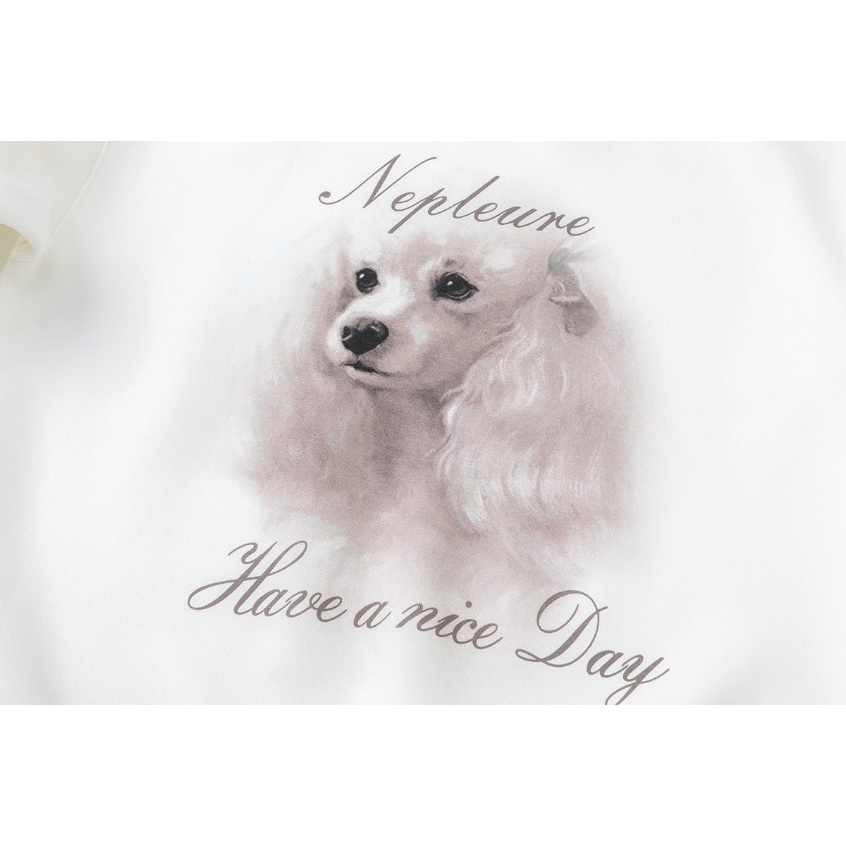 Close-up of a white sweatshirt printed with a watercolor dog and the words “Neptune” and “Have a nice Day.”