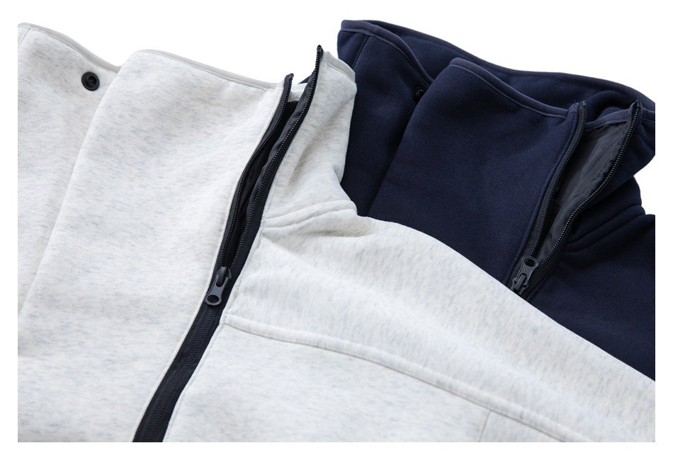 Two zip-front high-collar jackets in light gray and navy, shown partly open.
