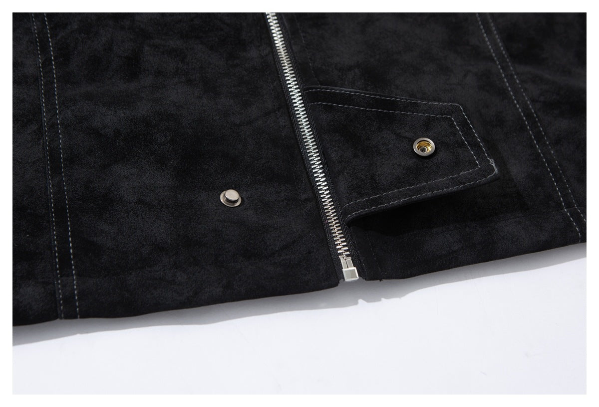 Close-up of a black jacket front with a silver zipper and snap-fastened flap.