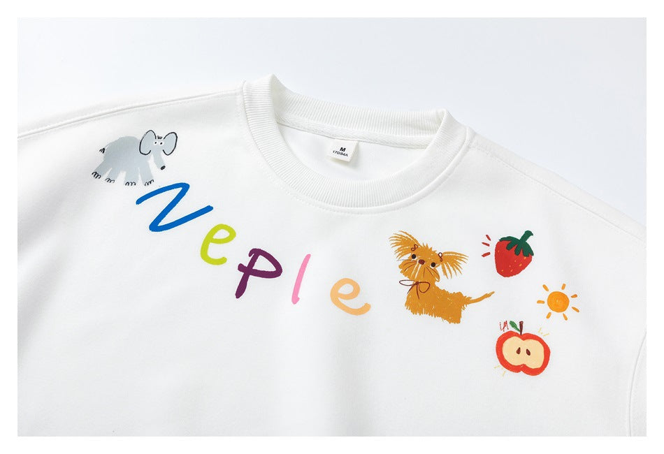 Cropped front view of a white crewneck sweatshirt with colorful letters and playful animal, fruit, and sun illustrations.