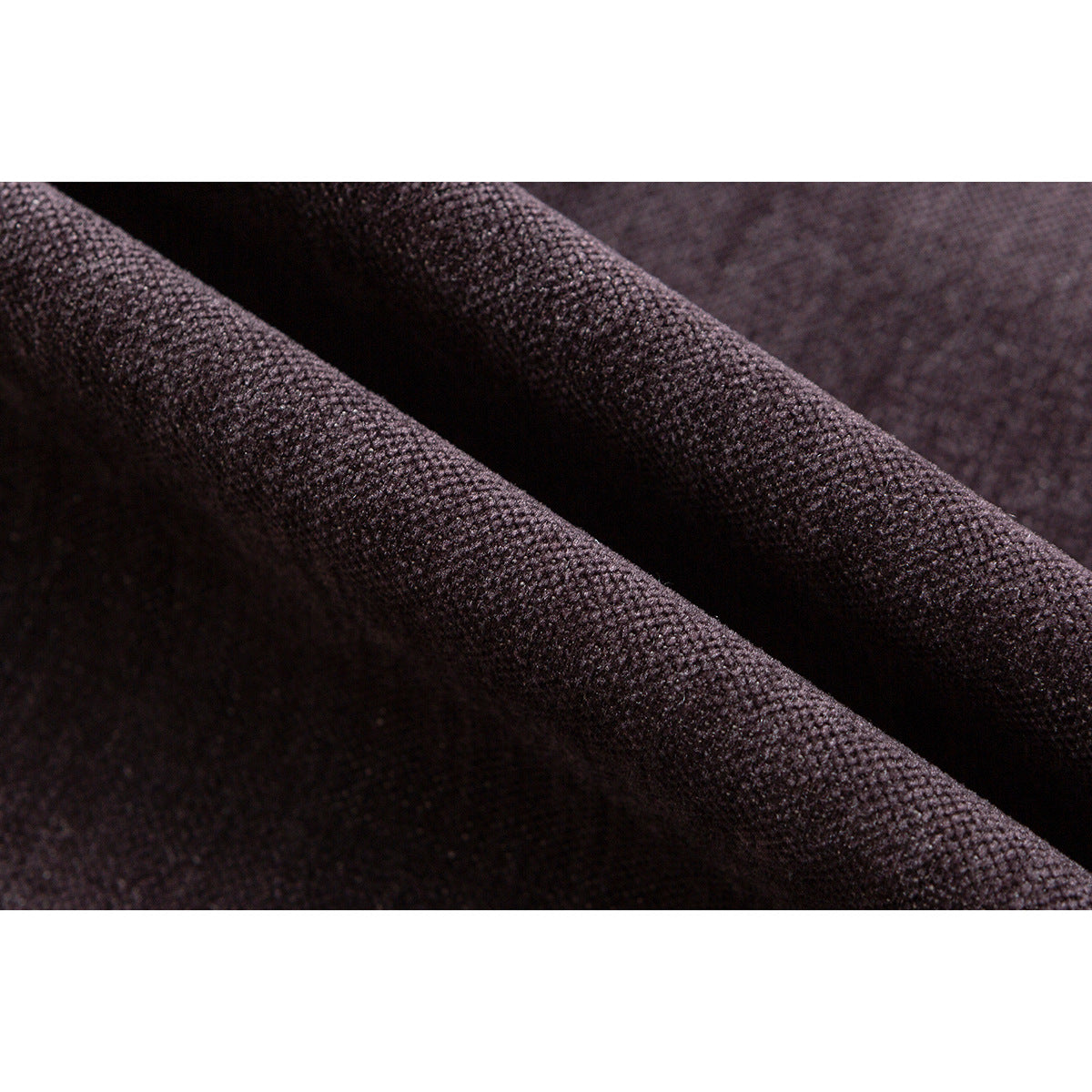 Extreme close-up of dark mauve-brown fabric showing its fine textured weave and folds.