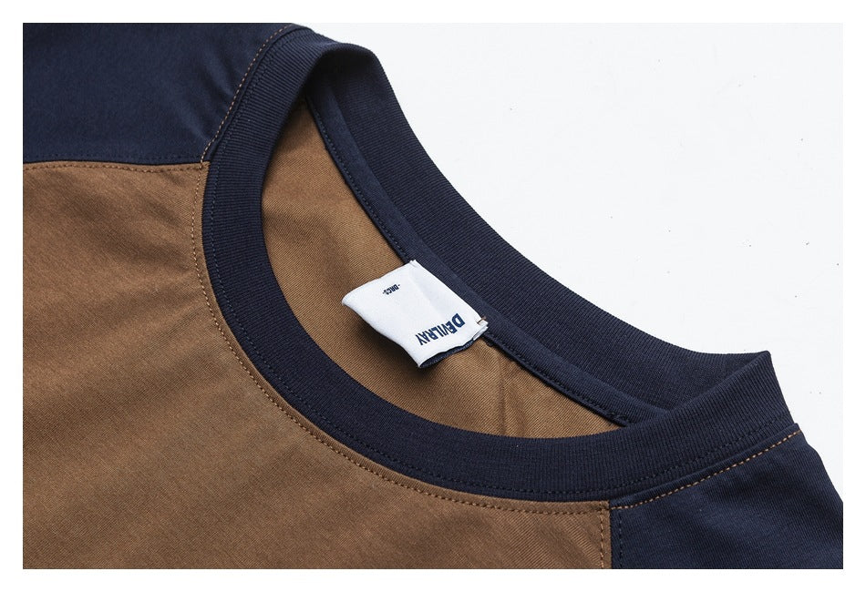 Close-up of a brown and navy color-block shirt neckline, ribbed trim, stitching, and interior label.
